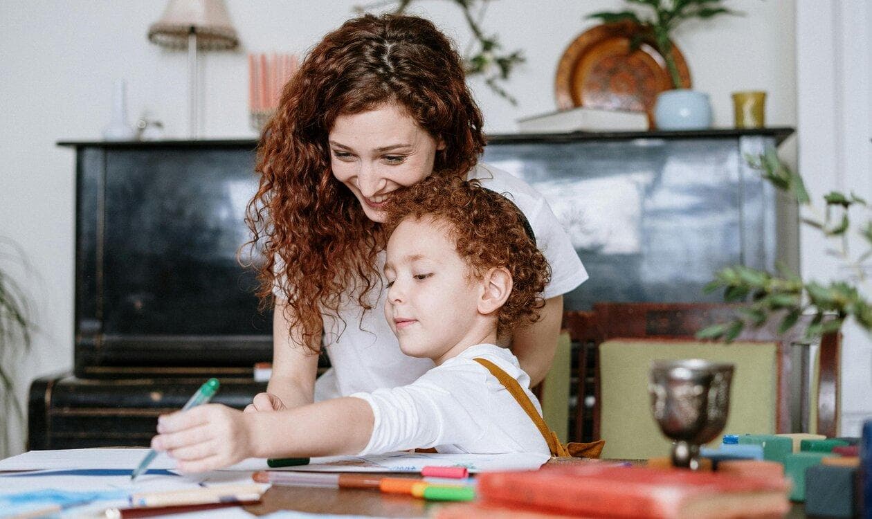 Parent helping a child with a learning activity at home