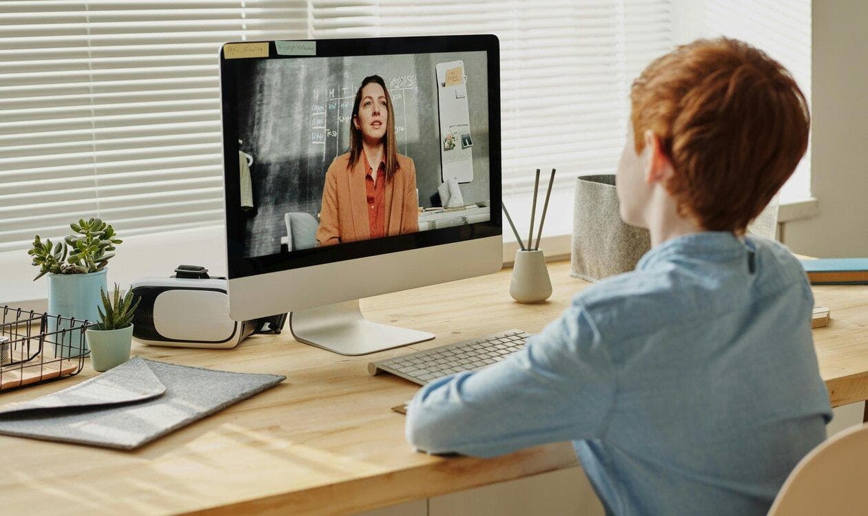Child on a video call with a speech-language pathologist